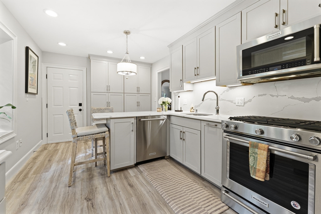 16 Preacher Road, Unit 16 Milton, MA 02186 - Photo 9 of 32 a kitchen with a sink stove and microwave