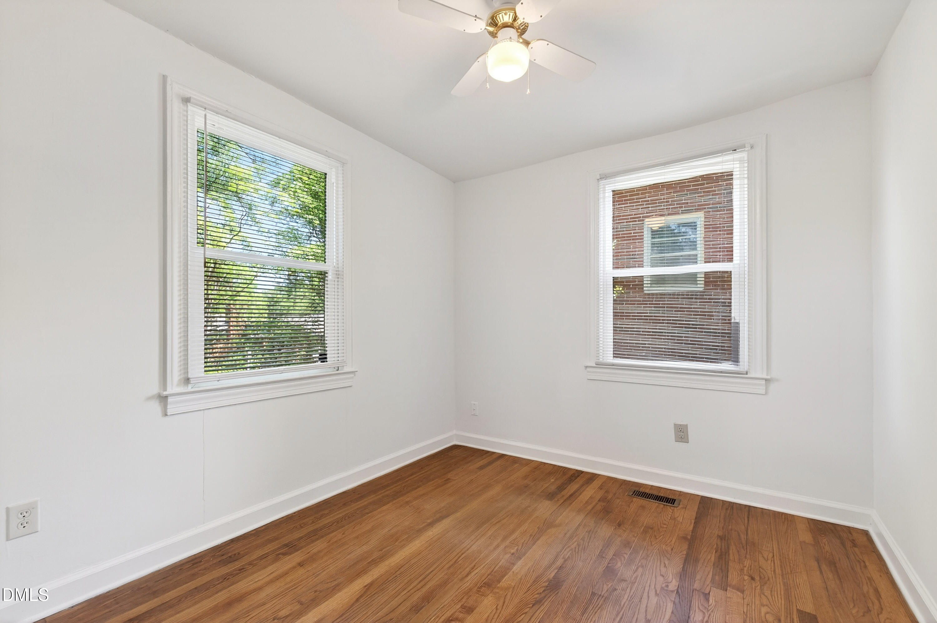 2316 Bedford Avenue Raleigh, NC 27607 - Photo 13 of 30 a view of an empty room with wooden floor and a window