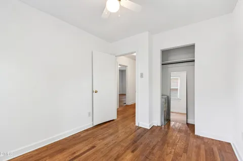 a view of an empty room with wooden floor