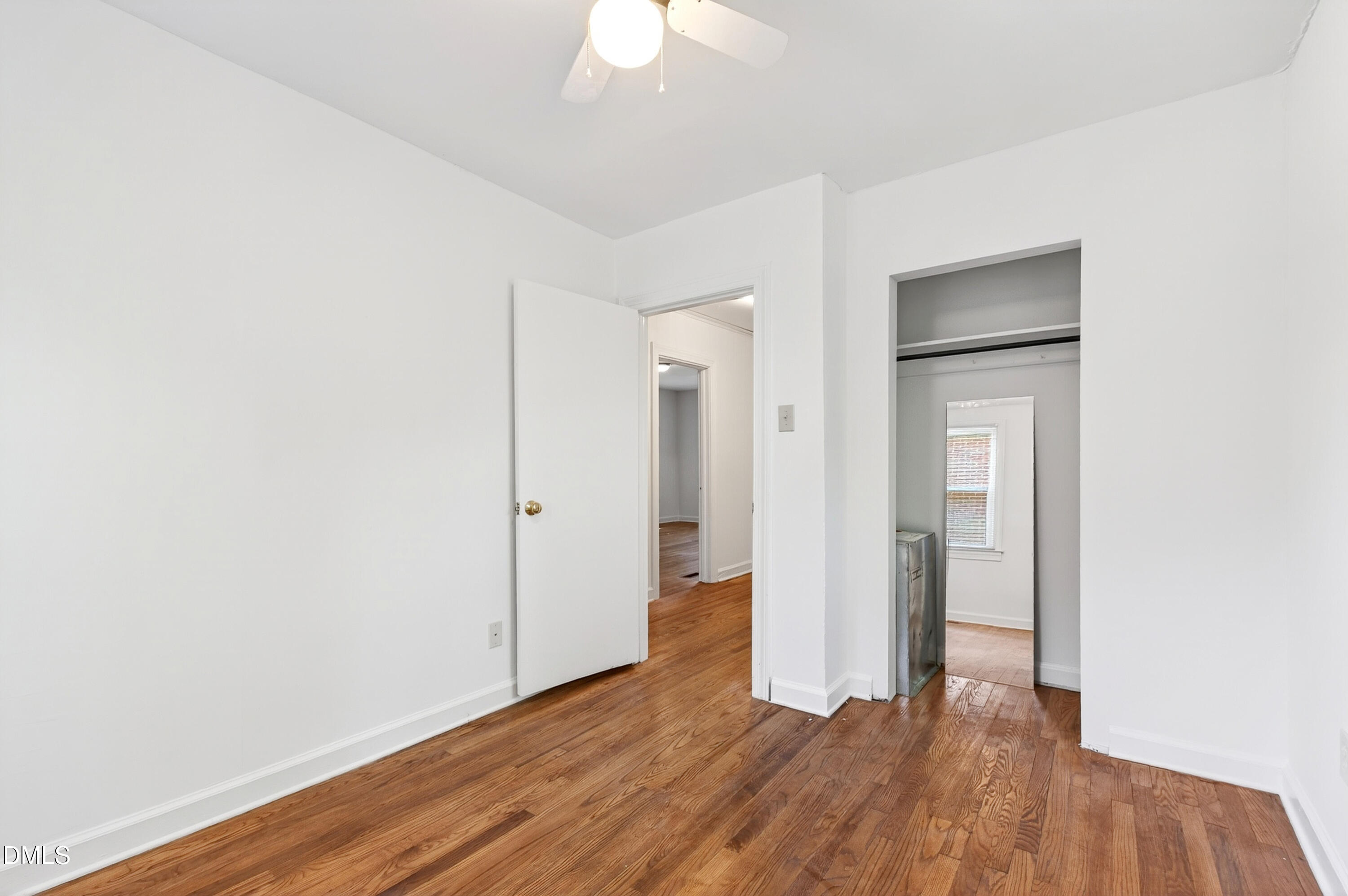 2316 Bedford Avenue Raleigh, NC 27607 - Photo 14 of 30 a view of an empty room with wooden floor and a ceiling fan
