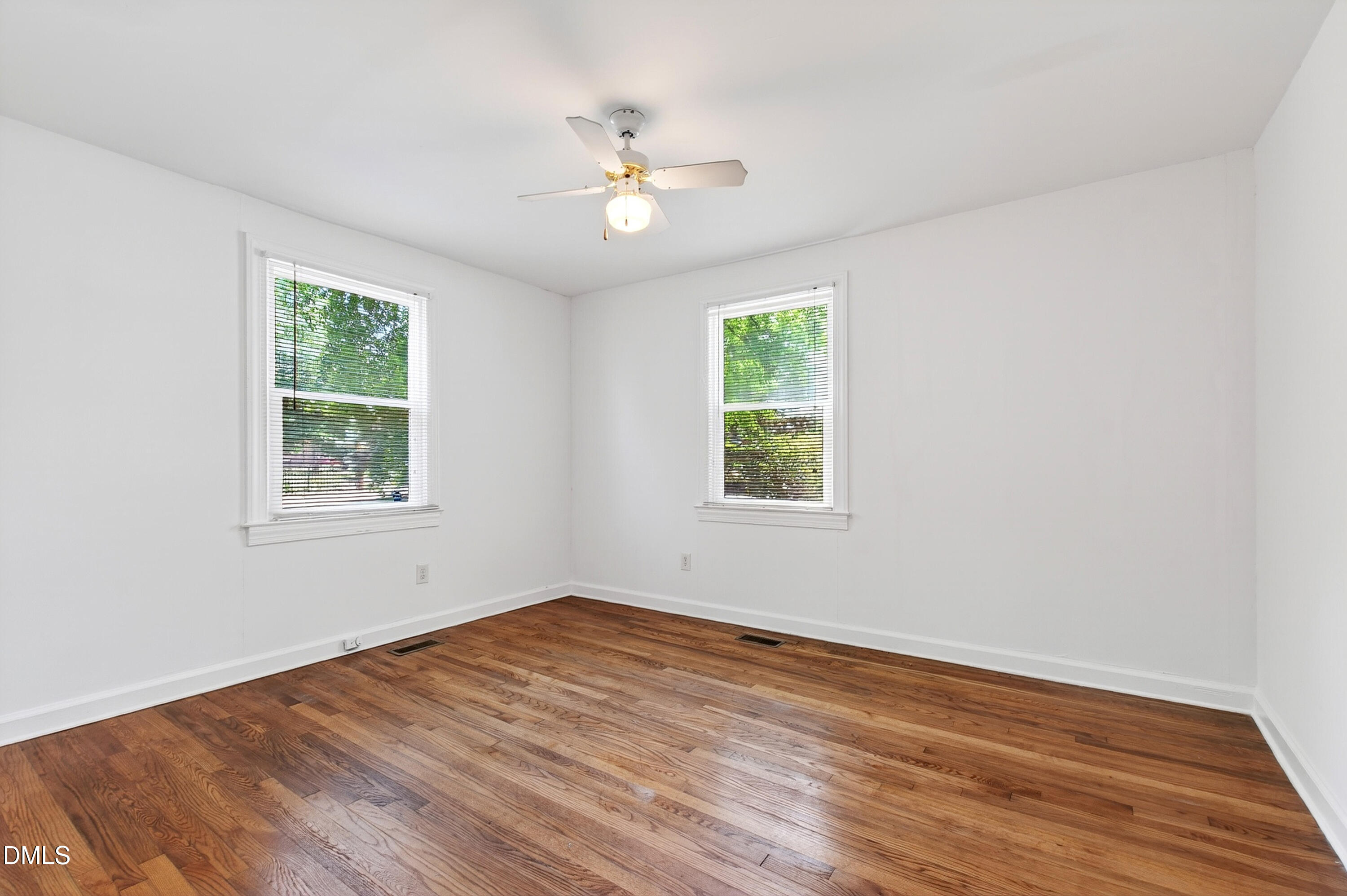 2316 Bedford Avenue Raleigh, NC 27607 - Photo 22 of 30 a view of an empty room with wooden floor and a window