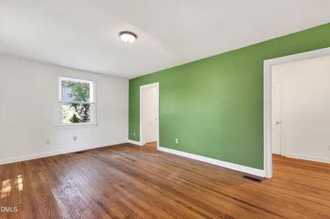 a view of room with window and wooden floor