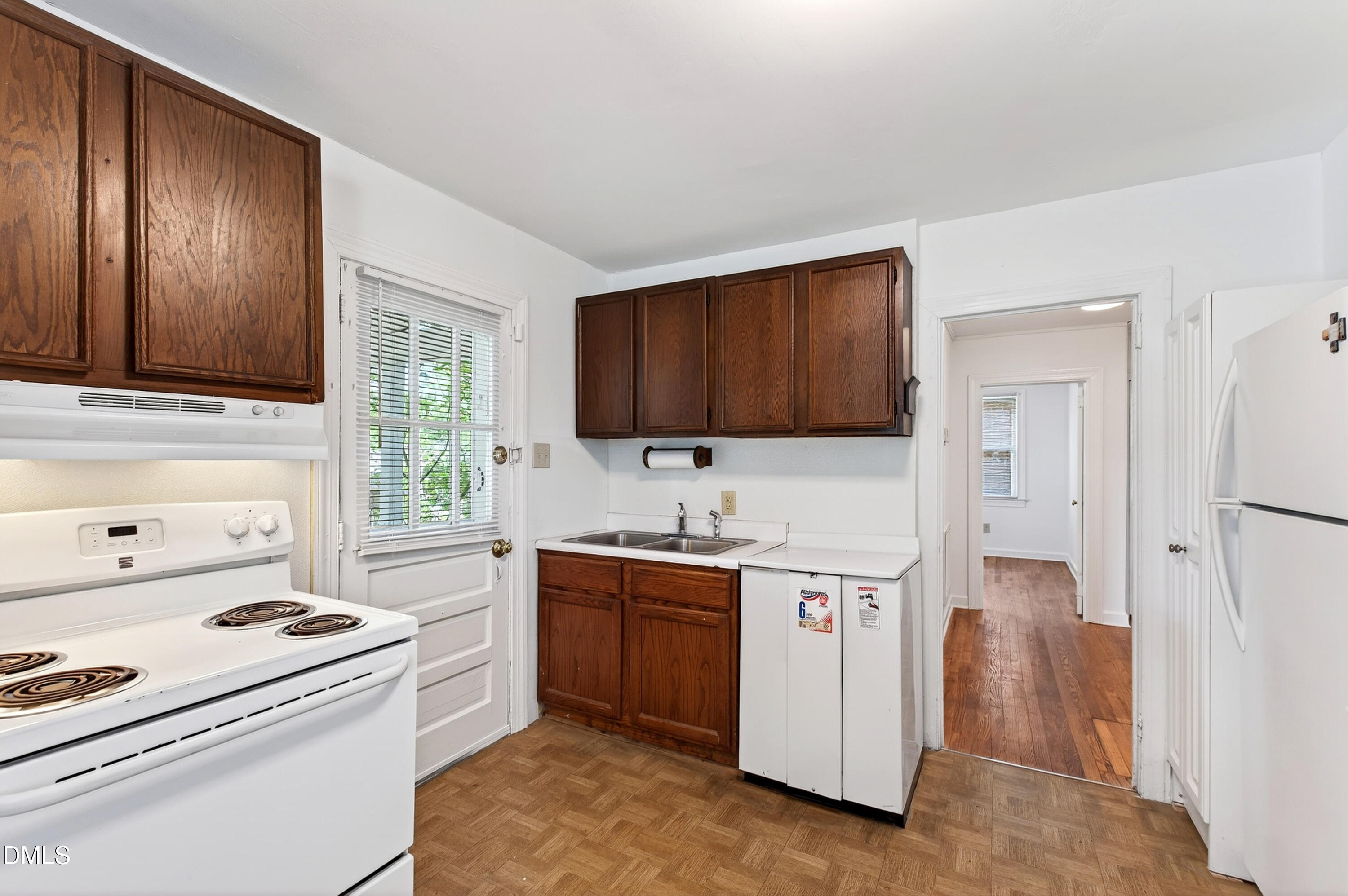 2316 Bedford Avenue Raleigh, NC 27607 - Photo 6 of 30 a kitchen with stainless steel appliances a stove a sink and a refrigerator
