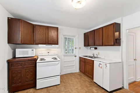 a kitchen with a refrigerator stove and sink