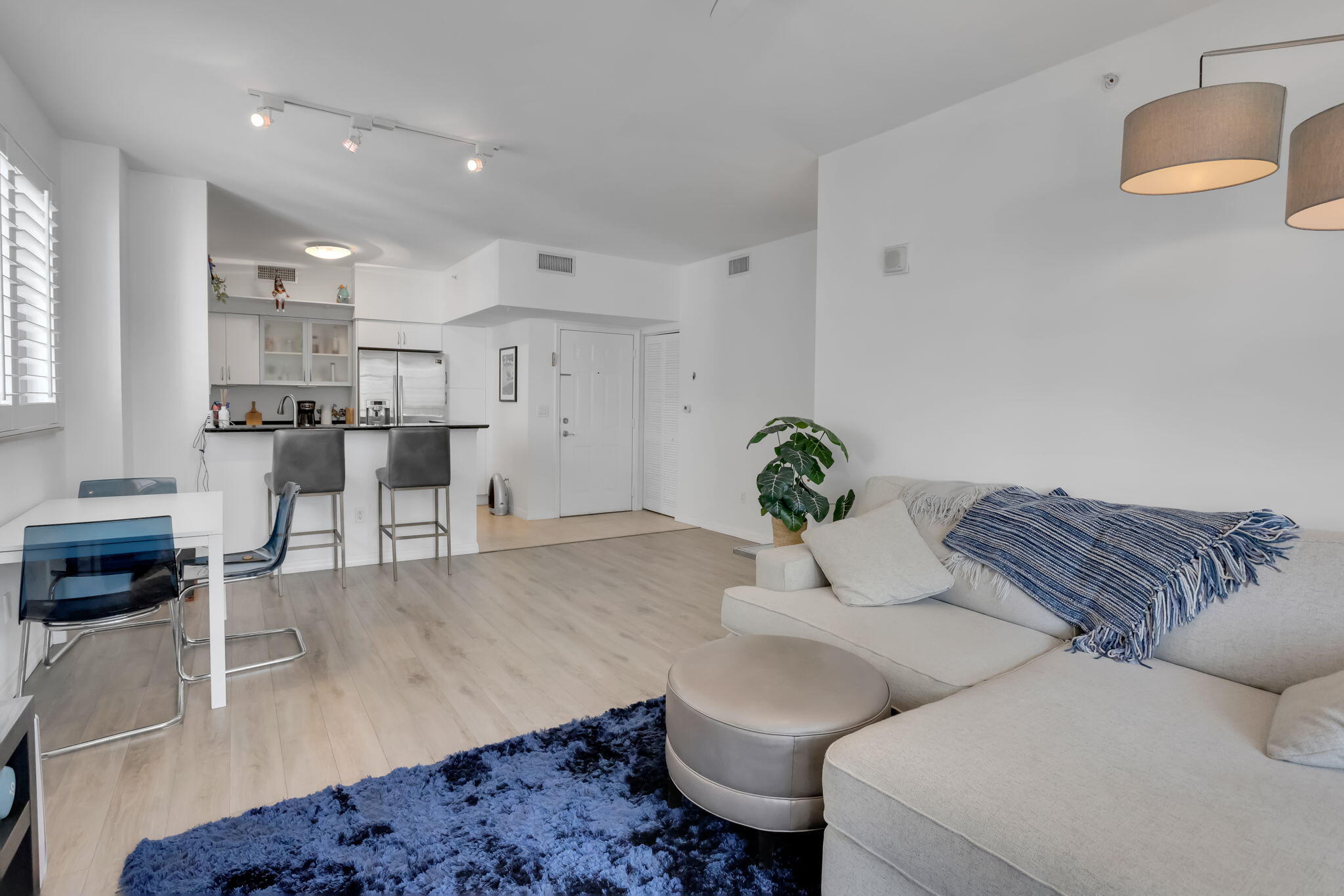 233 South Federal Highway, Unit 325 Boca Raton, FL 33432 - Photo 1 of 30 a living room with furniture and a potted plant