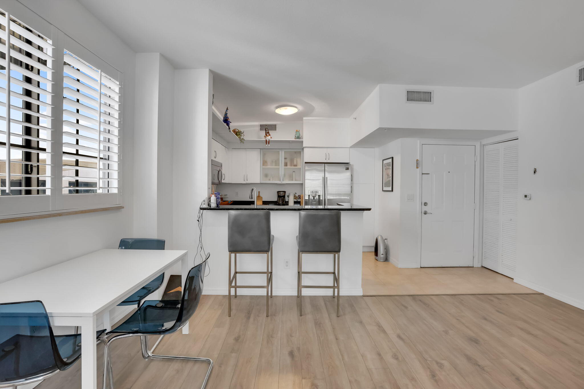 233 South Federal Highway, Unit 325 Boca Raton, FL 33432 - Photo 12 of 30 a view of kitchen with cabinets and wooden floor