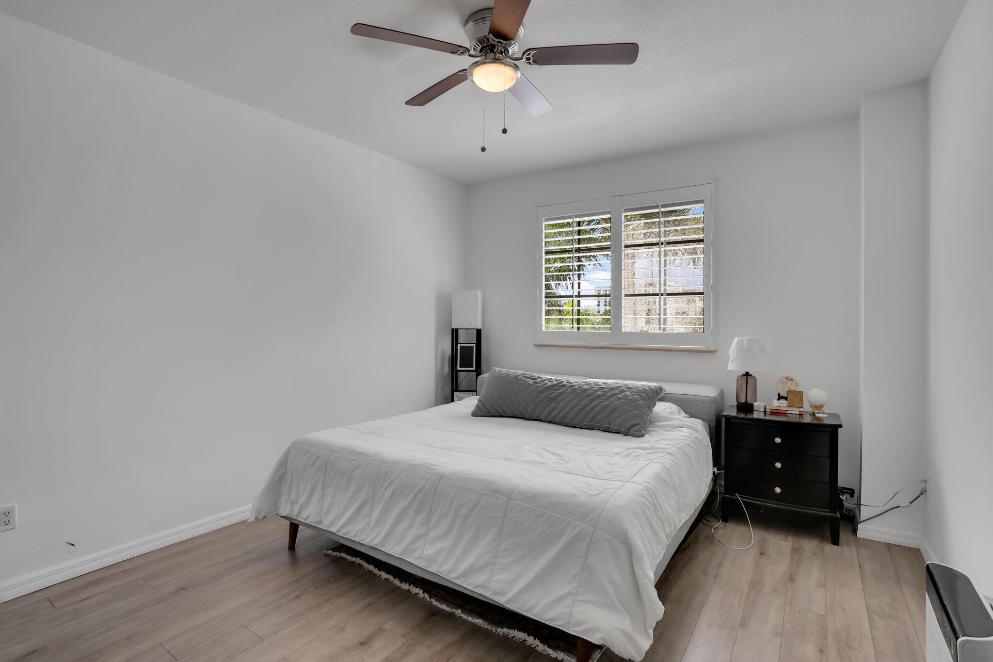 233 South Federal Highway, Unit 325 Boca Raton, FL 33432 - Photo 13 of 30 a bedroom with a bed and a chandelier