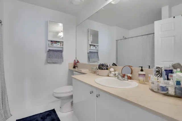a bathroom with a sink toilet and mirror