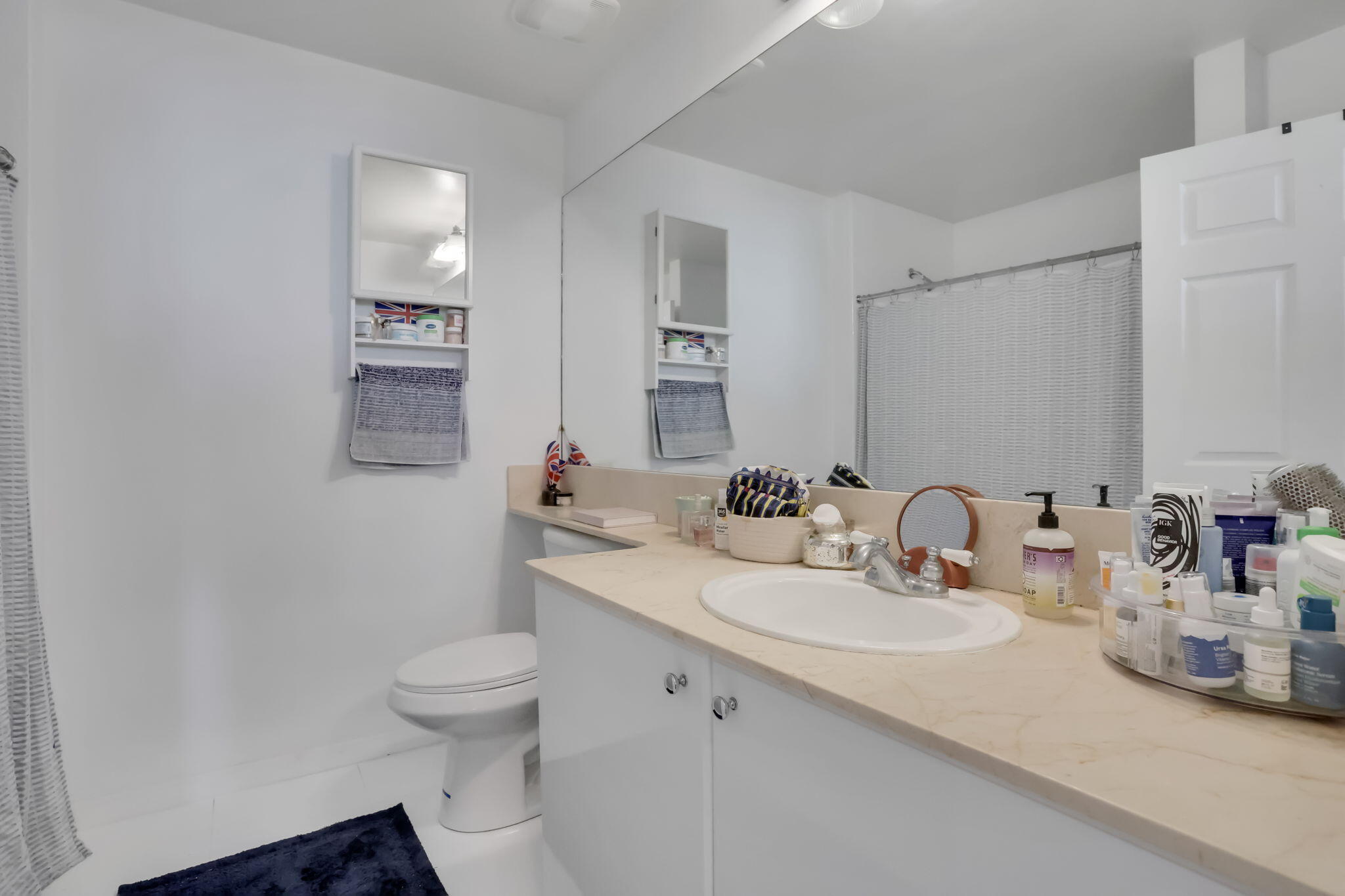 233 South Federal Highway, Unit 325 Boca Raton, FL 33432 - Photo 14 of 30 a bathroom with a sink toilet and mirror