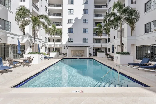 a view of a swimming pool with outdoor seating