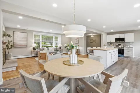 a view of kitchen with dining area refrigerator and window