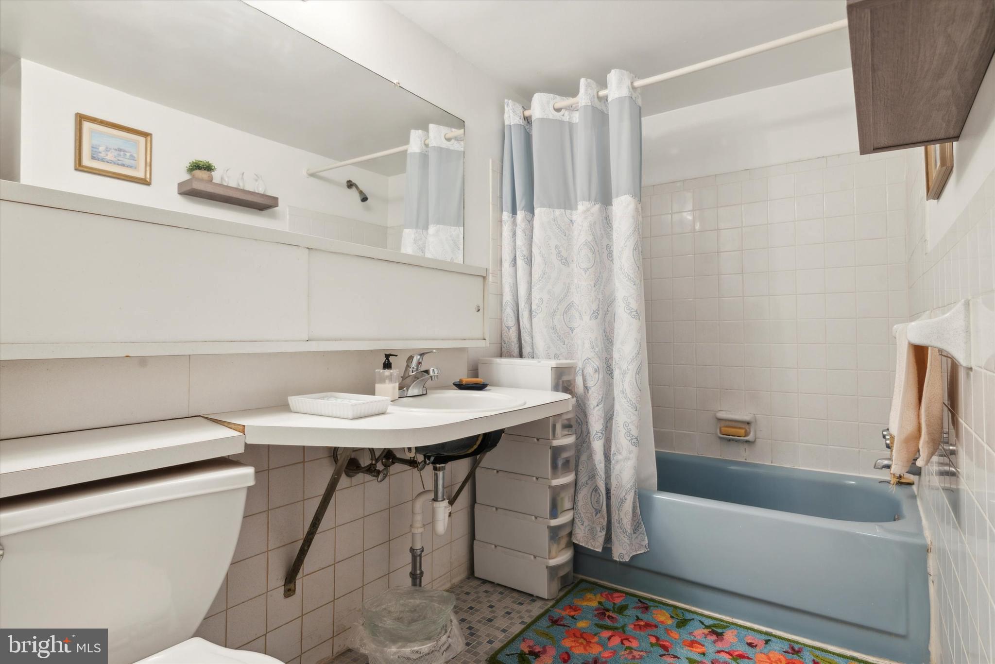 46 Township Line Road, Unit 209 Elkins Park, PA 19027 - Photo 15 of 15 a bathroom with a sink a toilet and a bathtub