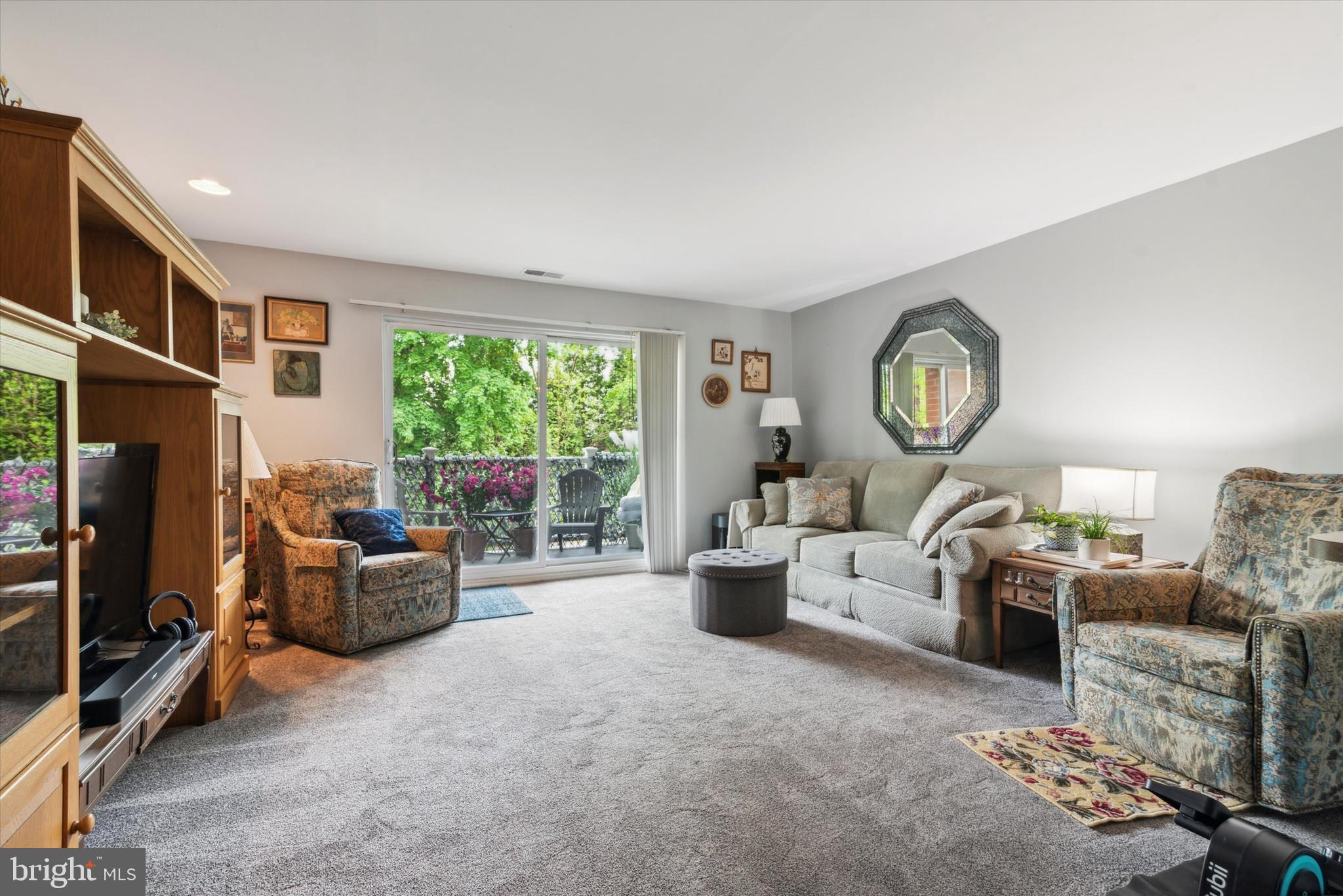 46 Township Line Road, Unit 209 Elkins Park, PA 19027 - Photo 2 of 15 a living room with furniture a fireplace and a large window