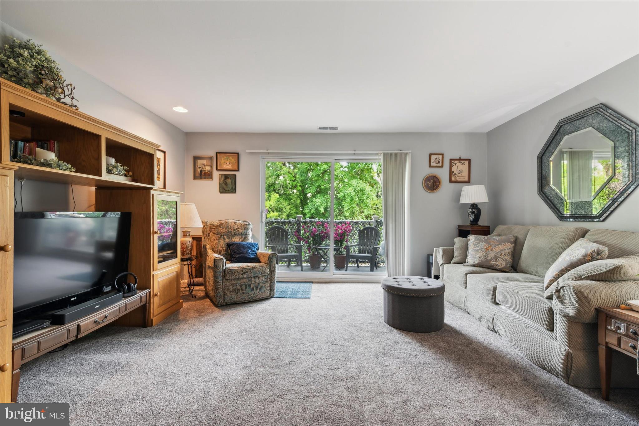 46 Township Line Road, Unit 209 Elkins Park, PA 19027 - Photo 4 of 15 a living room with furniture and a flat screen tv