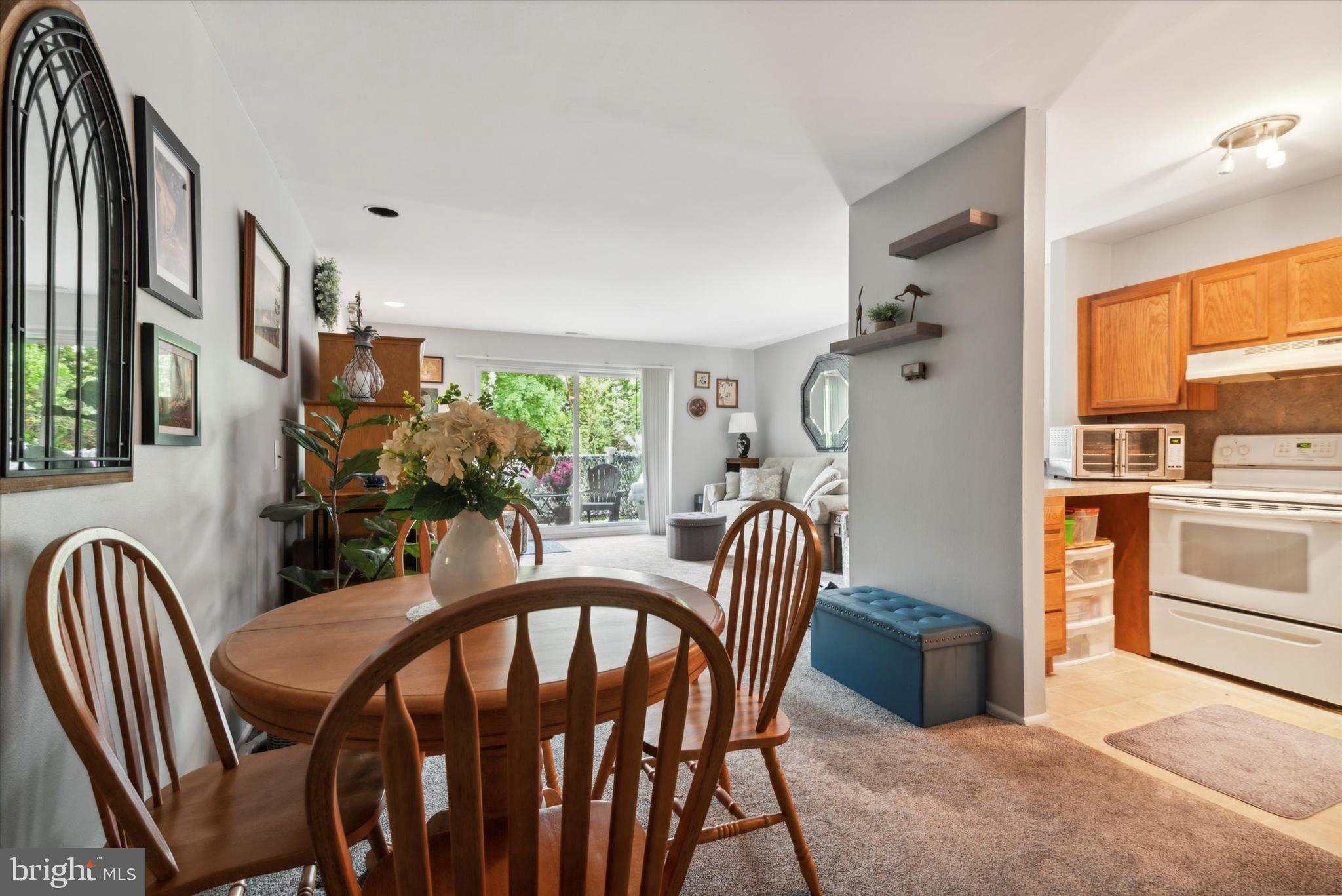 46 Township Line Road, Unit 209 Elkins Park, PA 19027 - Photo 8 of 15 a view of a dining room and livingroom with furniture window and wooden floor