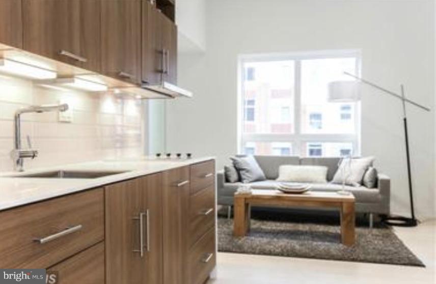 2422-2424 17th Street Northwest, Unit 201 Washington, DC 20009 - Photo 3 of 7 a living room with furniture and a large window