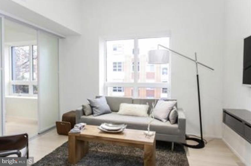 2422-2424 17th Street Northwest, Unit 201 Washington, DC 20009 - Photo 5 of 7 a living room with furniture and a window