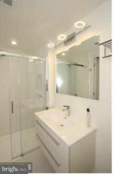 2422-2424 17th Street Northwest, Unit 201 Washington, DC 20009 - Photo 6 of 7 a bathroom with a sink a shower and a mirror