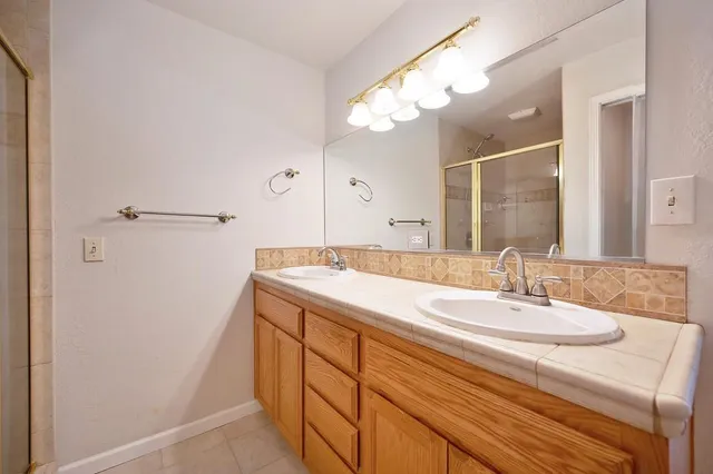 a view of a yard with plants and trees