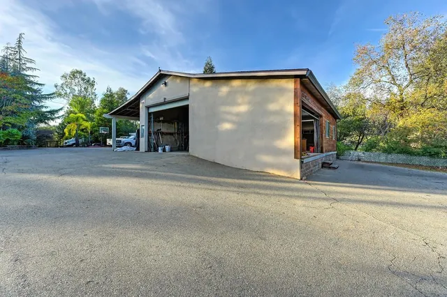 a backyard of a house with table and chairs