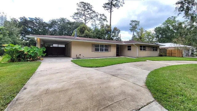 a front view of house with yard and green space