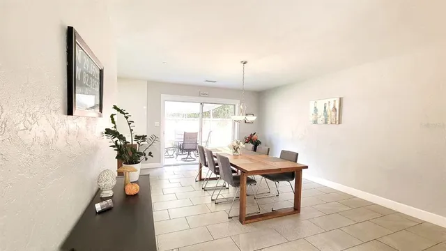 a room with patio furniture and a potted plant