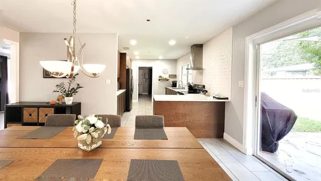 a kitchen with stainless steel appliances kitchen island granite countertop a refrigerator and a sink