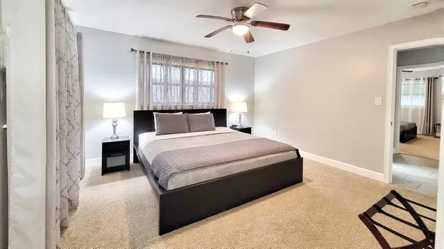 a bedroom with a bed and a chandelier