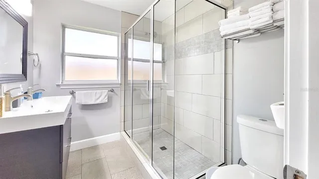 a bathroom with a shower sink and toilet
