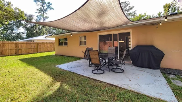 a view of a backyard with chair and tables