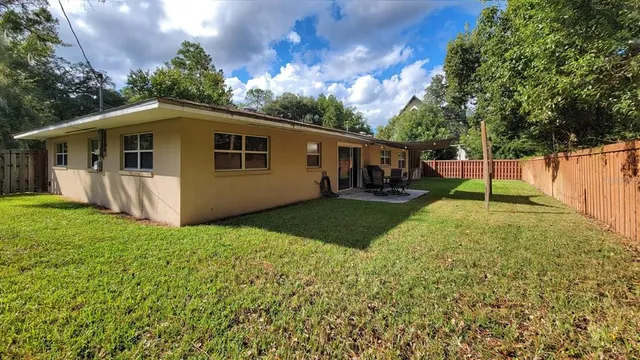 a view of a backyard with a garden and trees