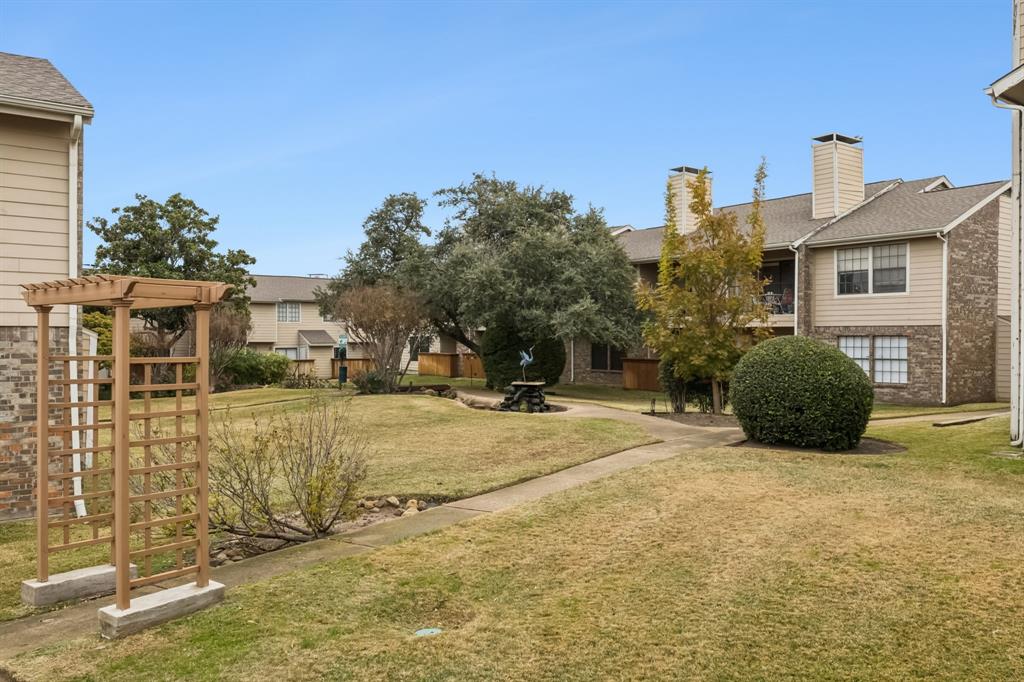 4748 Old Bent Tree Lane, Unit 1808 Dallas, TX 75287 - Photo 28 of 28 a view of a house with a yard