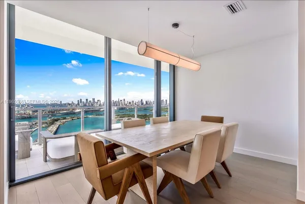 a view of a dining room with furniture wooden floor and chandelier