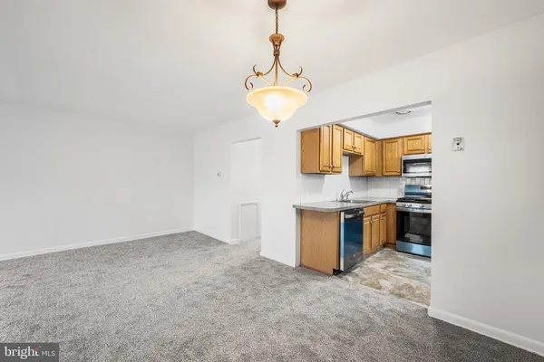 a kitchen with granite countertop a refrigerator and a sink