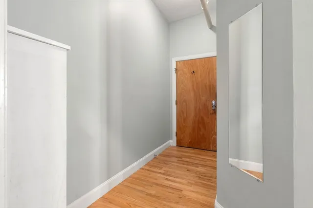 a view of a hallway with wooden floor