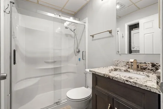 a bathroom with a sink toilet vanity and shower