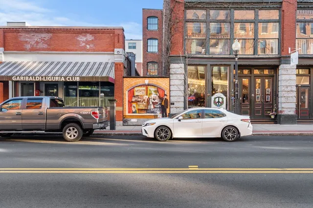 a view of a car is parked in front of a building