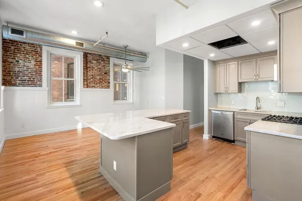 a kitchen with a sink stove and refrigerator