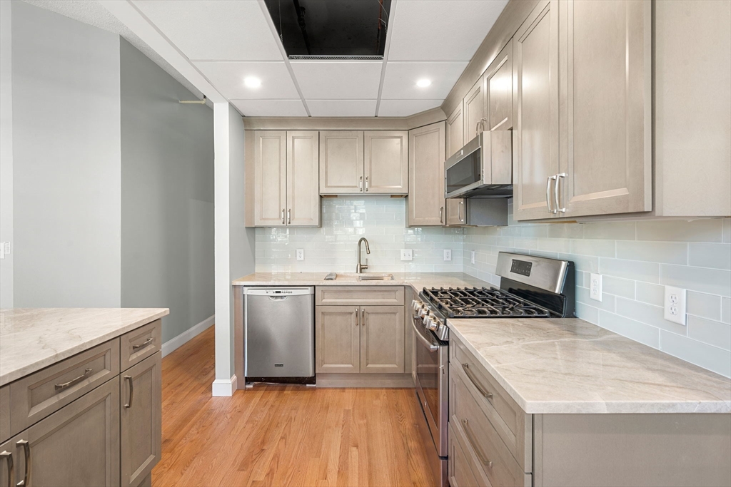 62 Washington Street, Unit 5 Haverhill, MA 01832 - Photo 6 of 34 a kitchen with a sink stove and cabinets