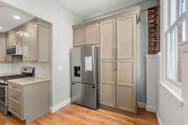 a view of a kitchen with electric appliances