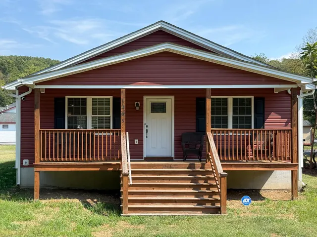 a view of a house with a window and a yard