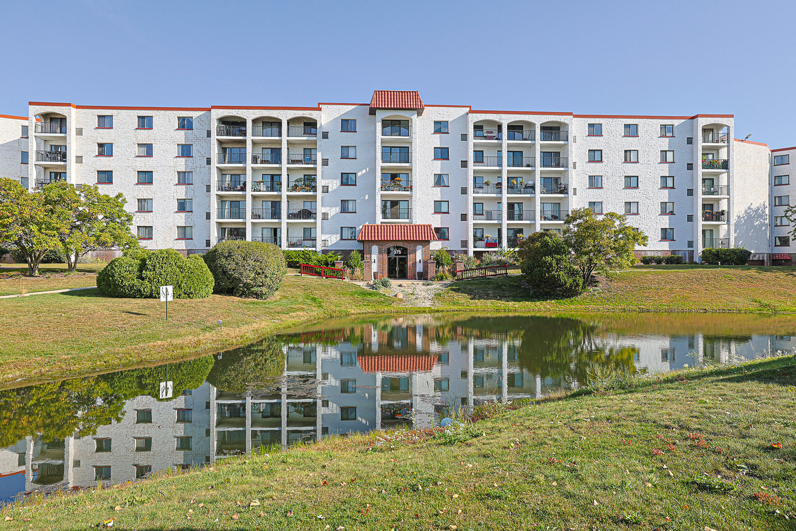 a front view of a building with a swimming pool