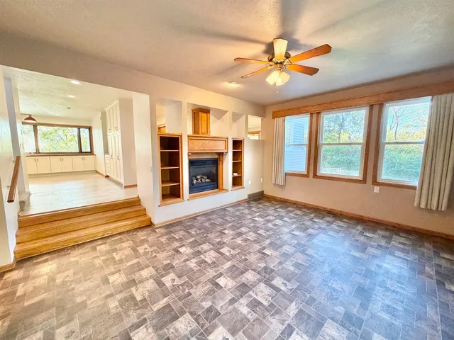 a bathroom with a granite countertop sink toilet and mirror