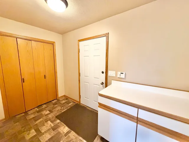 wooden floor in an empty room and a bathroom