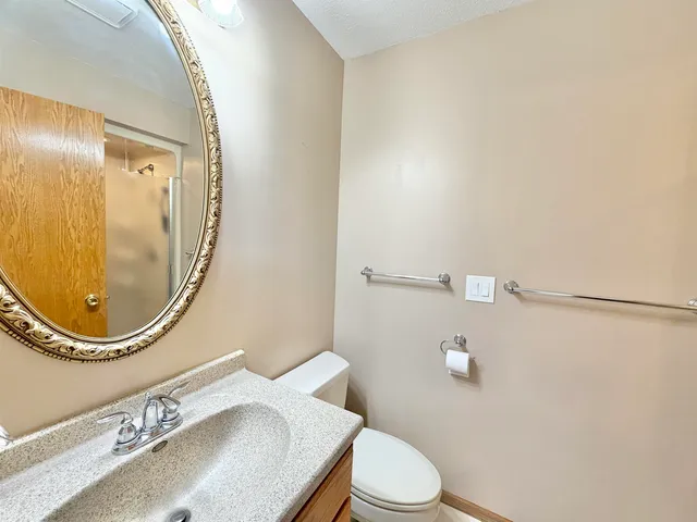 an empty room with windows and ceiling fan