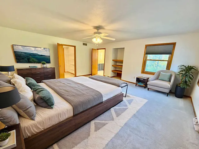 a spacious bathroom with a tub sink and mirror