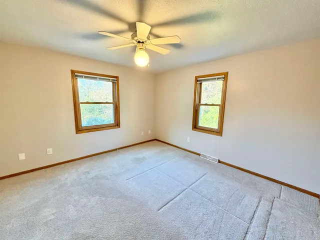 a view of an empty room with empty shelves