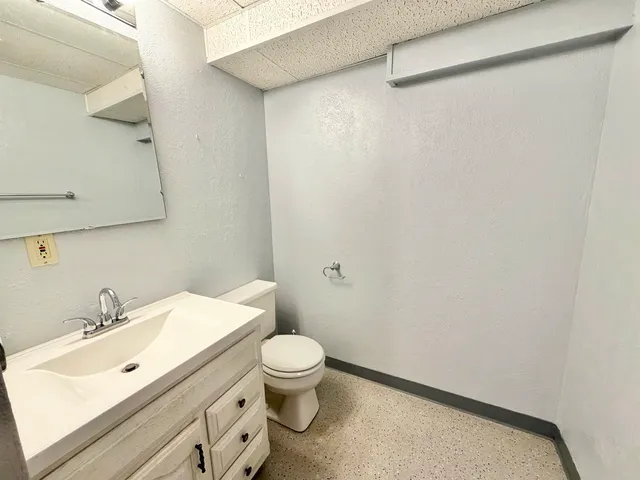 a view of green field with trees in the background