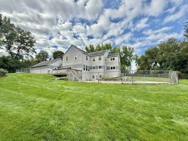 a view of a swimming pool with a yard