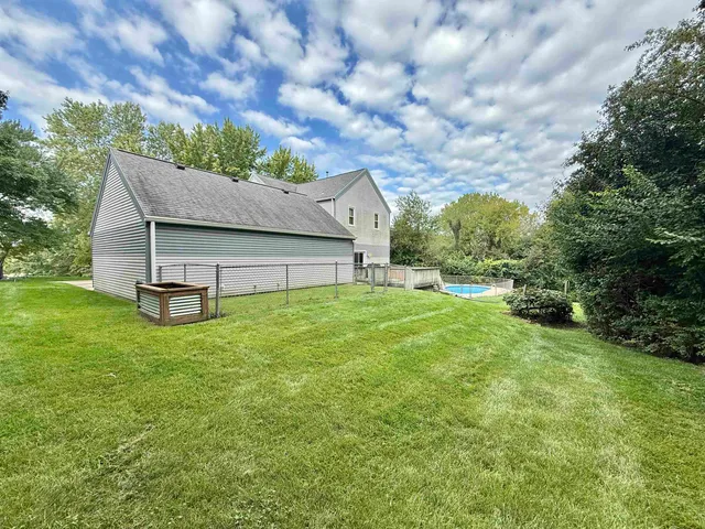 an aerial view of a house with a swimming pool and garden